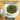 A white ceramic tea bowl with a lid on a wooden surface, filled with loose green tea leaves. Large text at the top reads '2026 Tea Arrivals Discover our newest teas' and a 'SHOP NOW' button appears at the bottom.