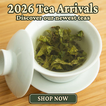 A white ceramic tea bowl with a lid on a wooden surface, filled with loose green tea leaves. Large text at the top reads '2026 Tea Arrivals Discover our newest teas' and a 'SHOP NOW' button appears at the bottom.