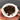 Hand holding a white dish with steeped Red Dawn tea leaves in it