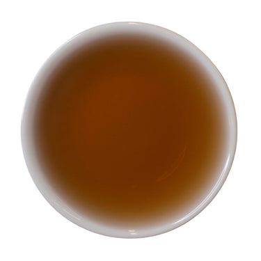 Steeped cup Dragon's Shadow Ripe Shu Puer tea cake